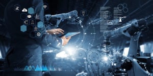 Manager Technical Industrial Engineer working and control robotics with monitoring system software and icon industry network connection on tablet. AI, Artificial Intelligence, Automation robot arm, smart manufacturing